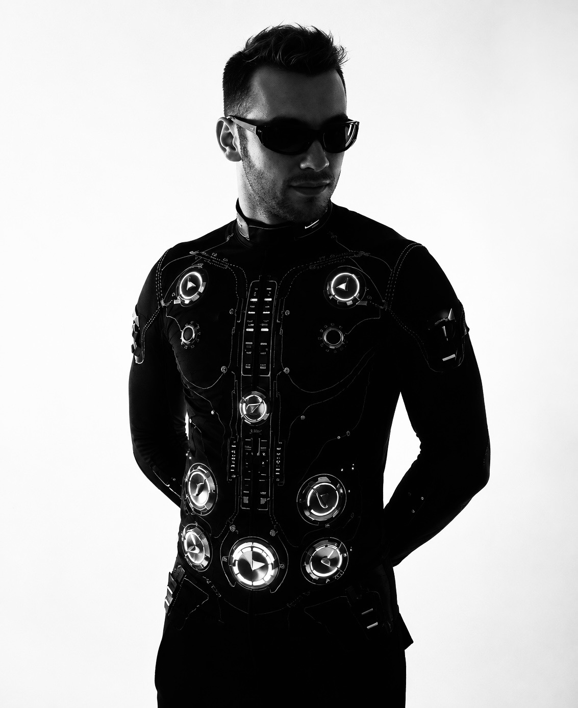 Mr. Movemixer in the glowing control suit, waist-up studio portrait